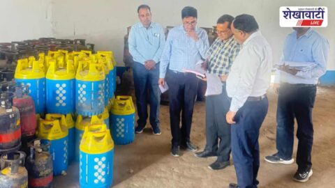 Officials inspecting LPG gas cylinders at Sikar gas agency