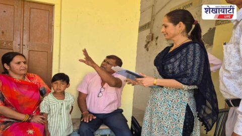 Education officer interacting with students during school inspection Sikar