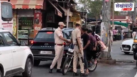 Traffic police checking helmets and seat belts in Chirawa market
