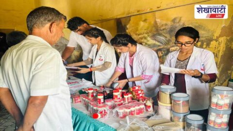 Doctors examining patients during free health camp in Dhanuri village