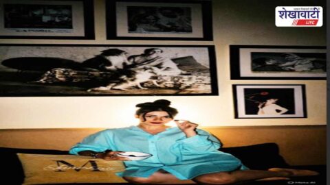 Tanisha Mukerji posing with family legacy portraits in background