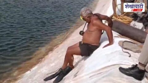 Rescue team recovering youth from farm water reservoir in Bidasar