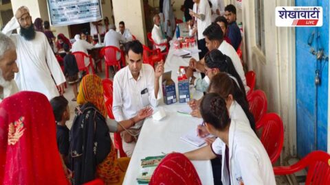 Doctors examining patients at free health camp in Jabasar
