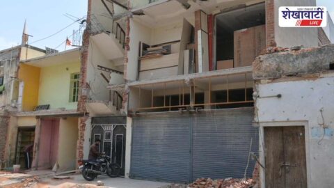 Shopkeepers removing encroachments during road widening in Sikar